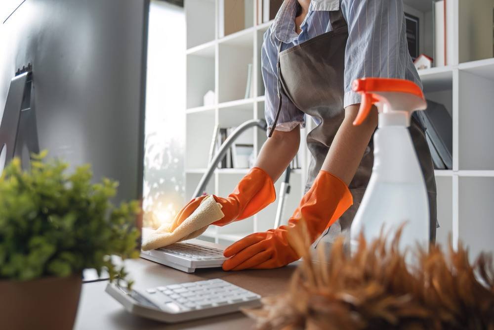 Cleaner wiping a surface in a luxury home